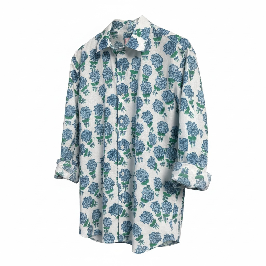 A long-sleeve button-up shirt with a white base and an allover blue and green hyacinth print, shown against a plain white background.